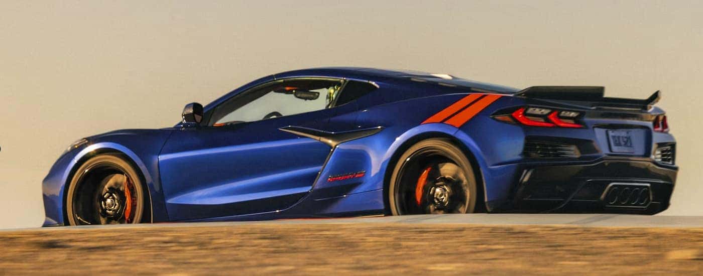 A blue 2027 Corvette Grand Sport driving on a track