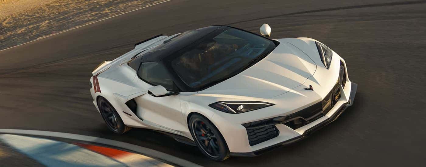 A white 2027 Corvette Grand Sport driving on a track