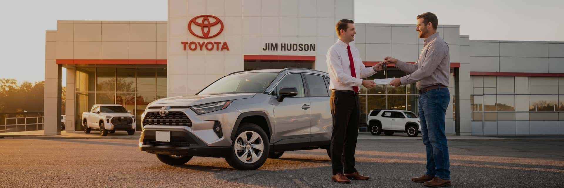 customer shaking hands with salesman at toyota dealership