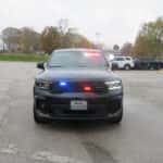 2025 Dodge Durango police SUV upfitted for a department with roof light bar and grille warning lights.