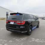 Rear view of a 2025 Dodge Durango patrol SUV with activated warning lights and tinted rear windows.