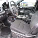 Interior view of a 2025 Dodge Durango police vehicle showing transport partition and mounted control console.