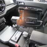 Interior view of a 2025 Dodge Durango police vehicle showing transport partition and mounted control console.