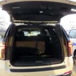 Rear view of three white 2025 Chevrolet Tahoe Fire and EMS units with emergency lighting.