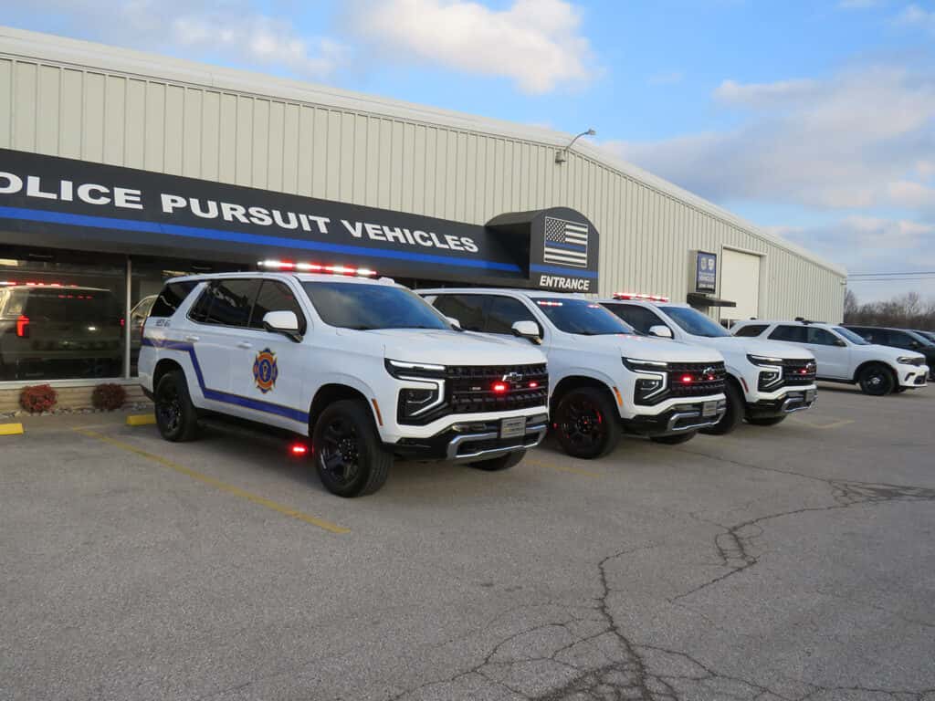 Three white 2025 Chevy Tahoe SUVs upfitted for Fire and EMS with roof light bars and emergency lighting.