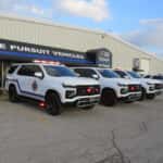 Three white 2025 Chevy Tahoe SUVs upfitted for Fire and EMS with roof light bars and emergency lighting.