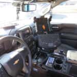 Interior of 2025 Chevrolet Silverado with police console and equipment