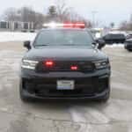 Front view of a 2025 Dodge Durango patrol unit with grille lights and roof-mounted emergency light bar.