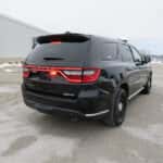 Rear view of a 2025 Dodge Durango patrol SUV with activated warning lights and tinted rear windows