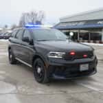2025 Dodge Durango police SUV upfitted for a New York department with roof light bar and grille warning lights.