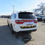 Rear three-quarter angle of a 2025 Dodge Durango patrol SUV with push bumper and rear flashers.