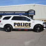 Side profile of a 2025 Dodge Durango police unit featuring push bumper and full emergency lighting package.