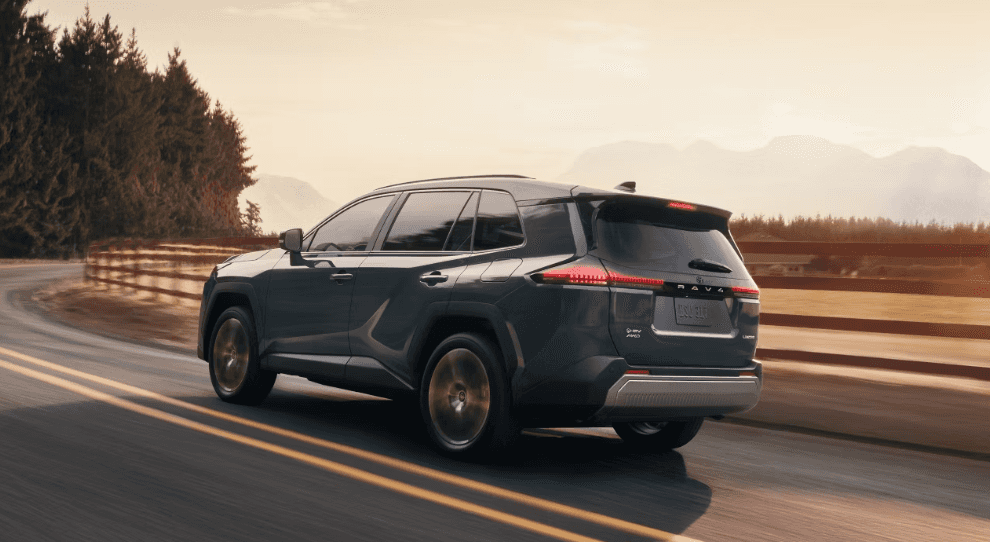The new 2026 Toyota RAV4 drives down a coastal highway.
