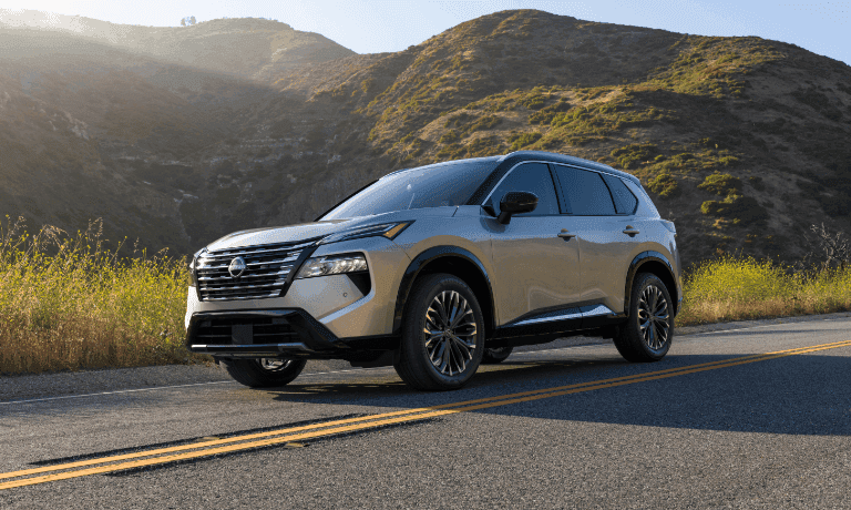 2025 Nissan Rogue driving in the hills