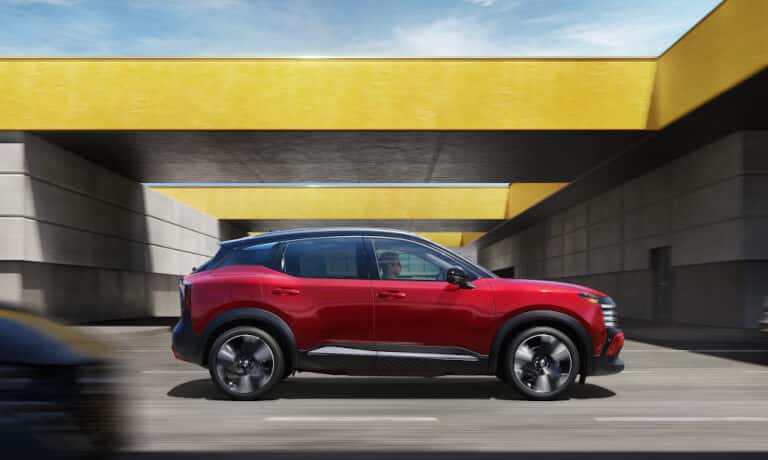 2025 Nissan Kicks side view driving underpass