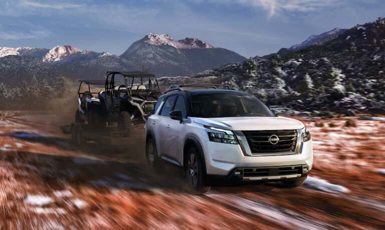 2025 Nissan Pathfinder towing ATVs in mountains