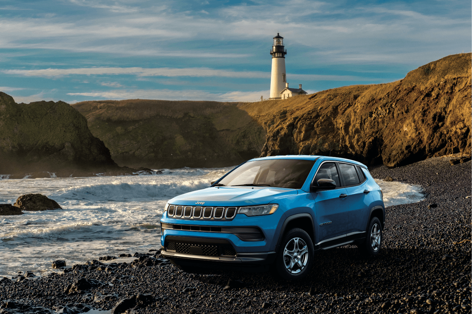 Jeep Compass pictured in a coastal driving scene representing Haines, Alaska outdoor lifestyle