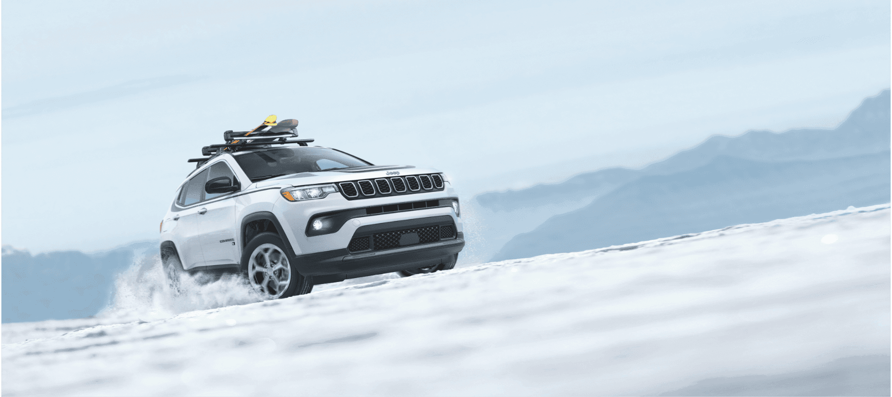 Jeep Compass parked in Juneau, Alaska with mountains and water nearby