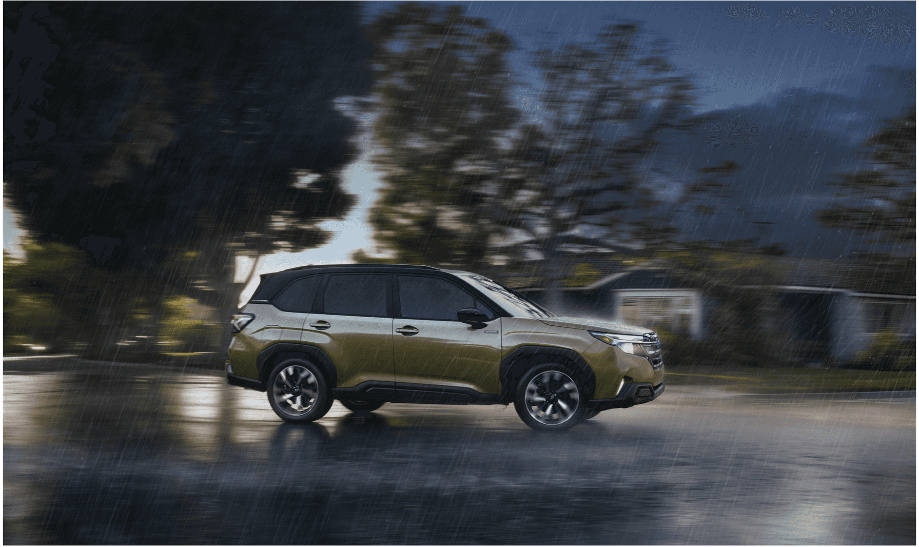 Subaru Forester driving on a wet Juneau road
