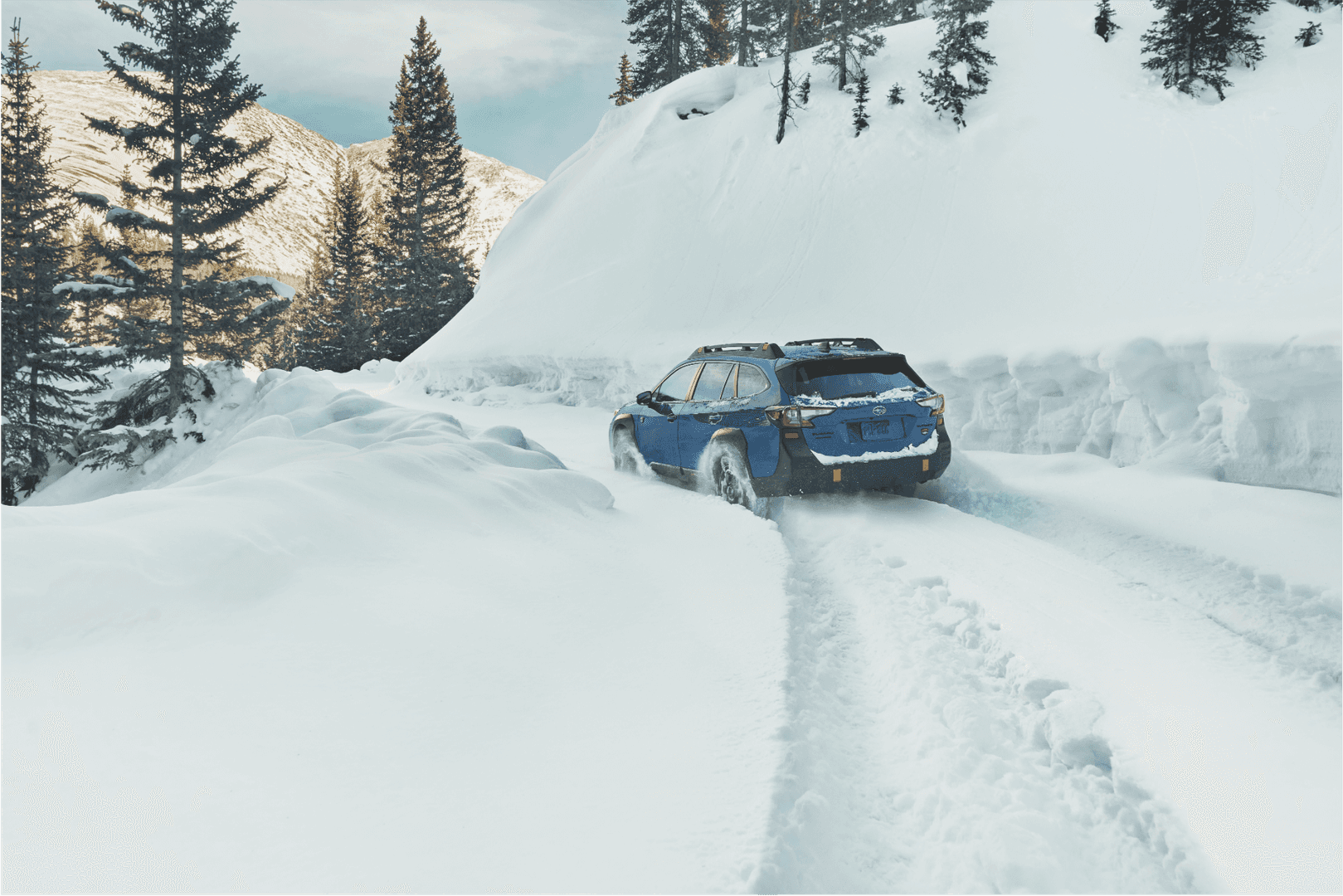 Subaru Outback Wilderness cresting a snowy rise