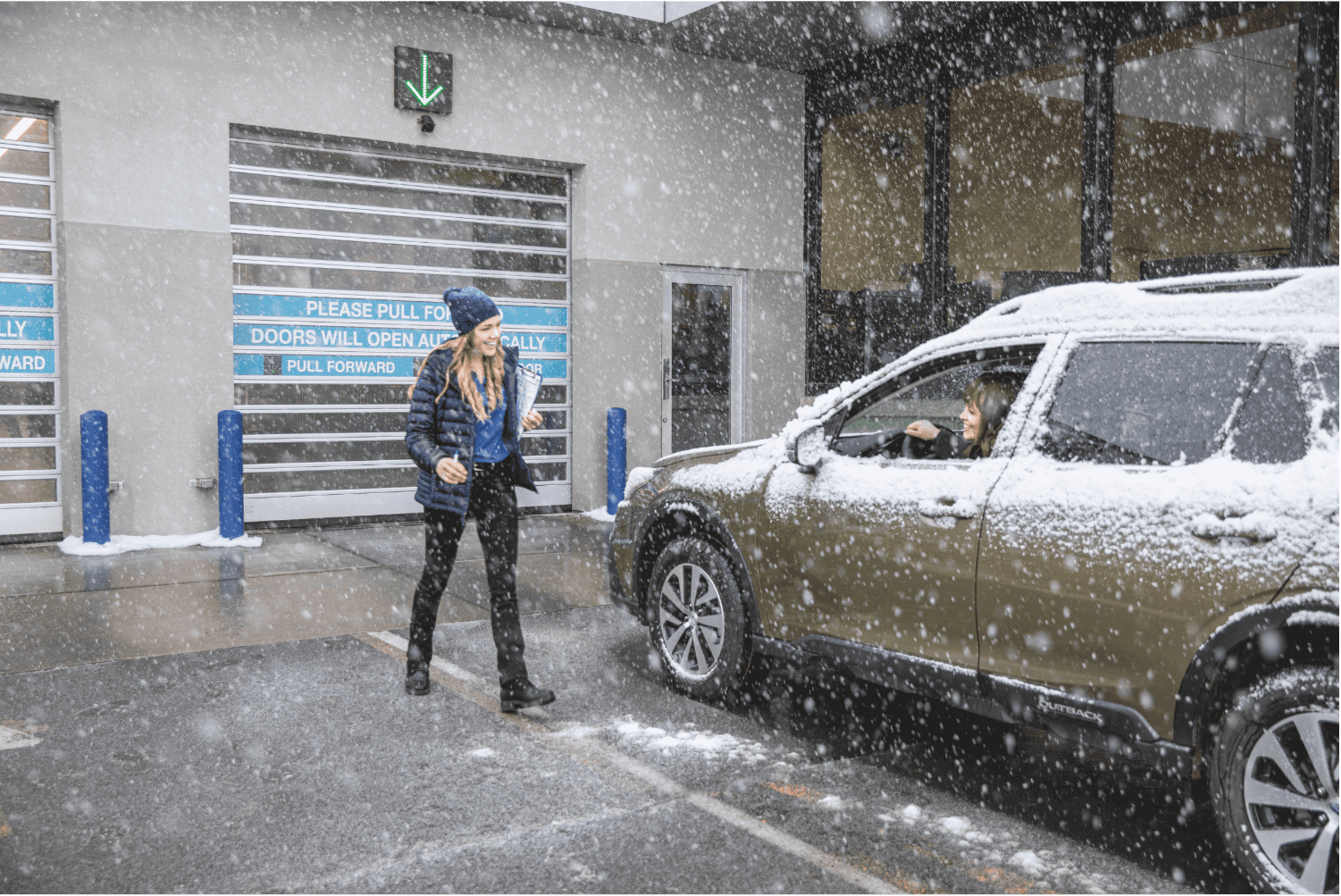 A customer arriving at the Juneau Subaru service check in lane during snowfall in Juneau, Alaska