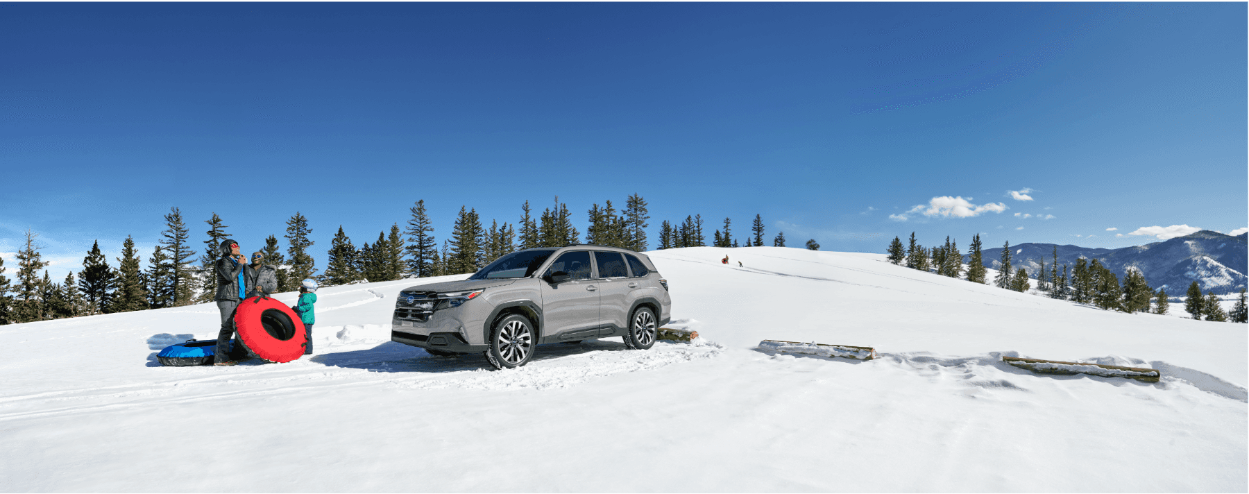 Family loading a Subaru Forester on a snowy day in Juneau