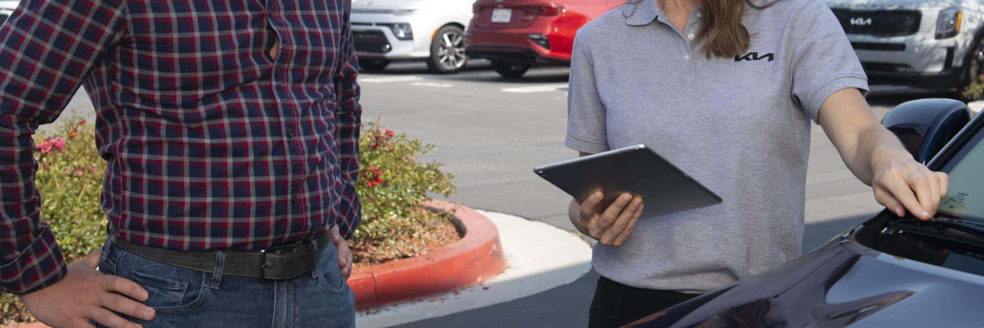 Service-technician-holding-tablet-and-talking-with-customer