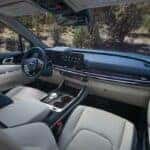 Passenger-side interior view of the 2026 Kia Carnival Hybrid highlighting the center console and spacious dashboard
