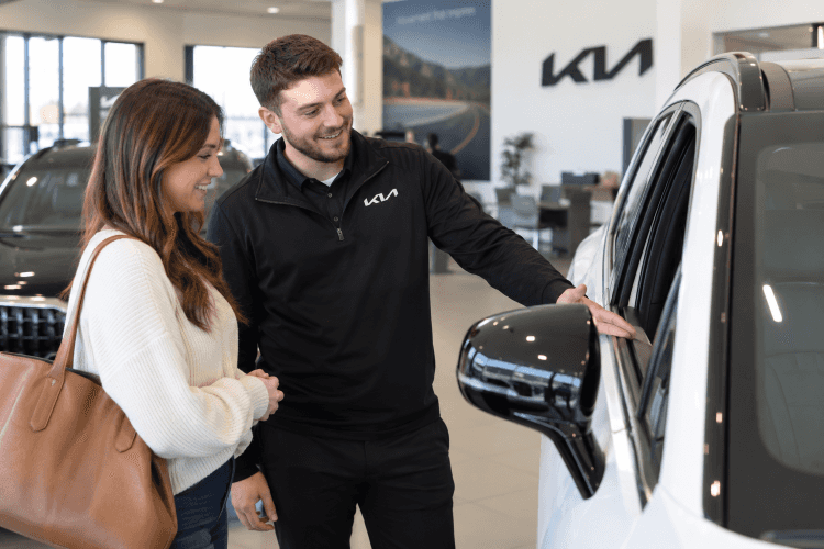 Kia of Lincoln team helping a customer