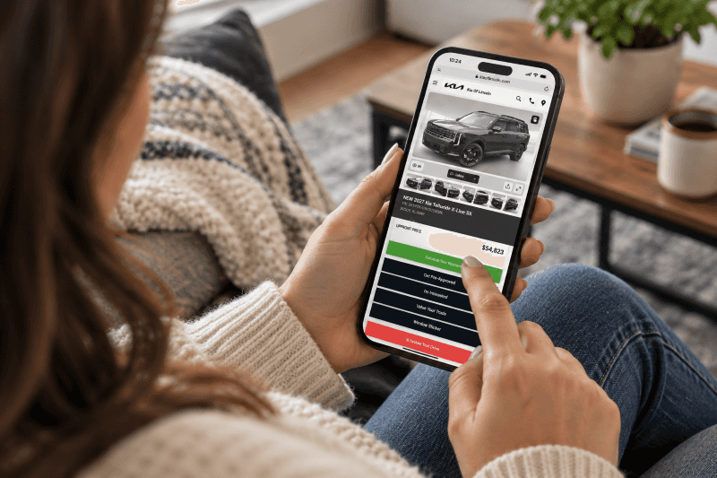 Customer browsing a Kia Telluride on the Kia of Lincoln website from home using a smartphone