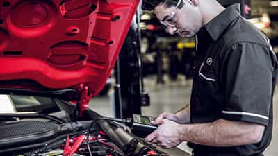 Mercedes-Benz technician working on a vehicle