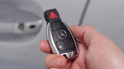 Hand holding a Mercedes-Benz keyfob