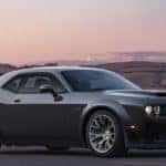 A black 2023 Dodge Challenger SRT Black Ghost is shown at sunset.