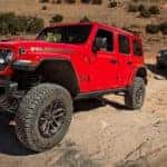 A red 2024 Jeep Wrangler 392 is shown after leaving a Jeep Wrangler dealer.