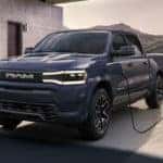 A blue 2024 Ram 1500 REV is shown charging after leaving a Ram dealer near Concord.