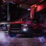 A popular Ram 1500 for sale, a red 2024 Ram 1500 TRX, is shown parked in an alleyway.