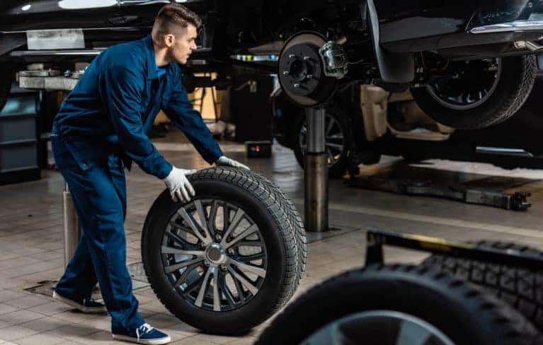 A technician installing a wheel.