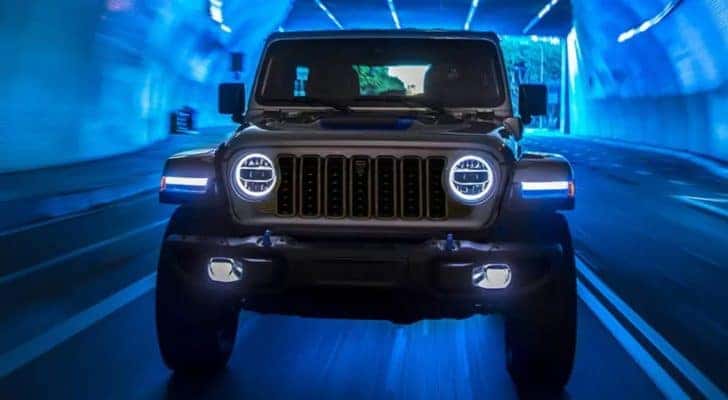 A grey 2024 Jeep Wrangler 4xe driving in a tunnel.