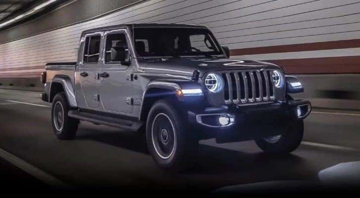 A grey 2024 Jeep Gladiator driving through a tunnel.