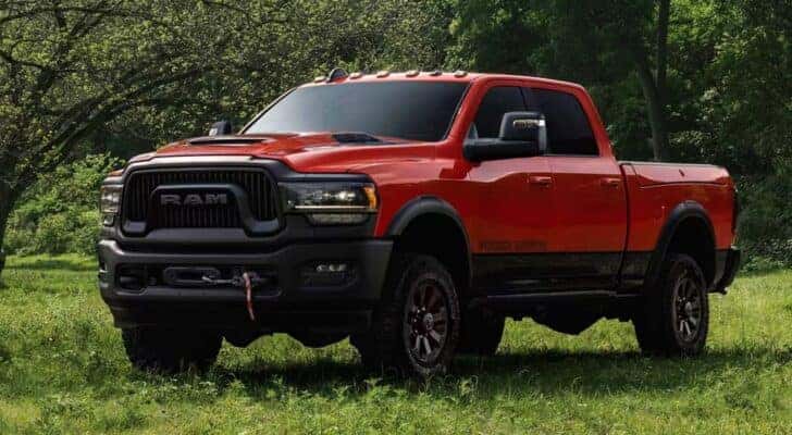 A red 2024 Ram 2500 Power Wagon parked in a grassy field.