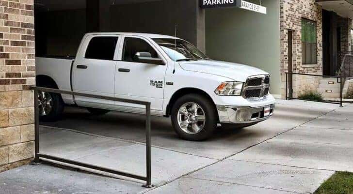 A white 2024 Ram 1500 Tradesman is shown parked at a parking garage after visiting a Ram dealer near Charlotte.