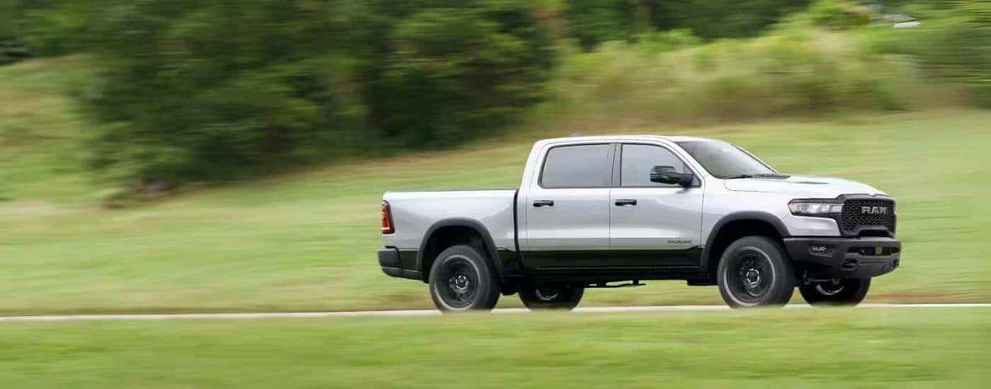Silver 2025 Ram 1500 driving on an open road