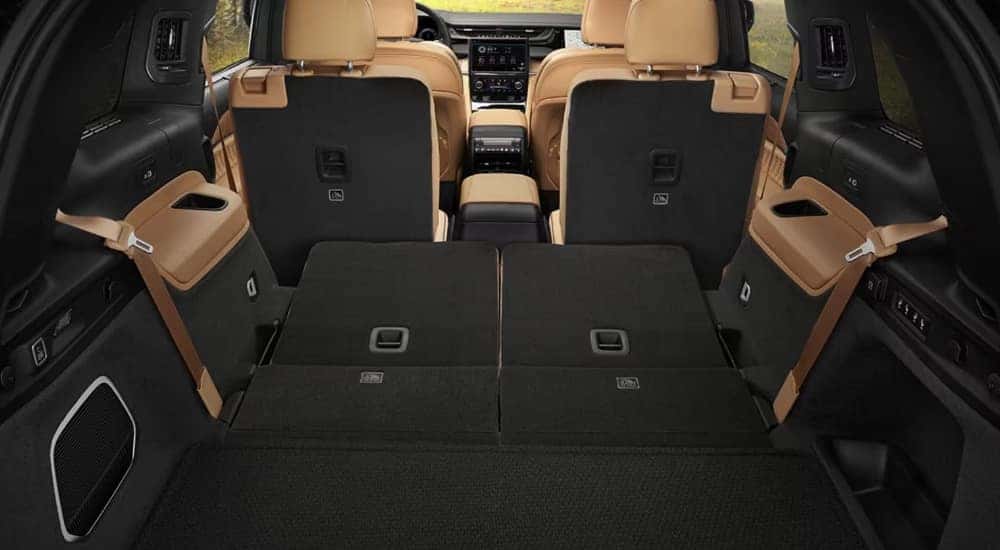 The tan interior of a 2025 Jeep Grand Cherokee L is shown from the rear.