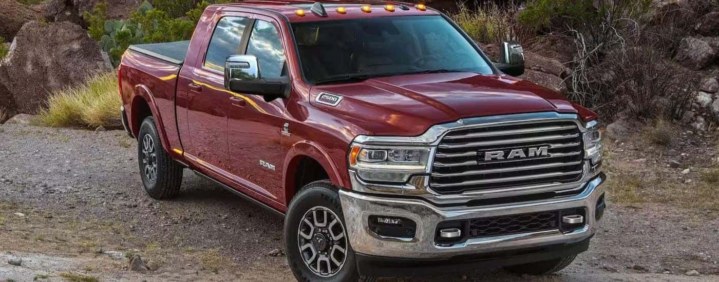 A red 2024 Ram 2500 parked off-road and angled right.