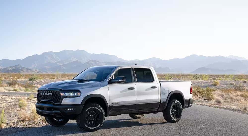 A blue 2025 Ram 1500 Rebel is shown from the front at an angle.