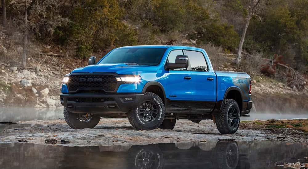 A blue 2025 Ram 1500 Rebel is shown from the front at an angle.
