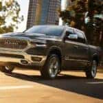A black 2019 Ram 1500 driving to view a used Ram for sale.