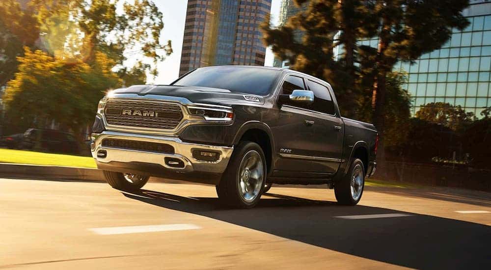 A black 2019 Ram 1500 driving to view a used Ram for sale.