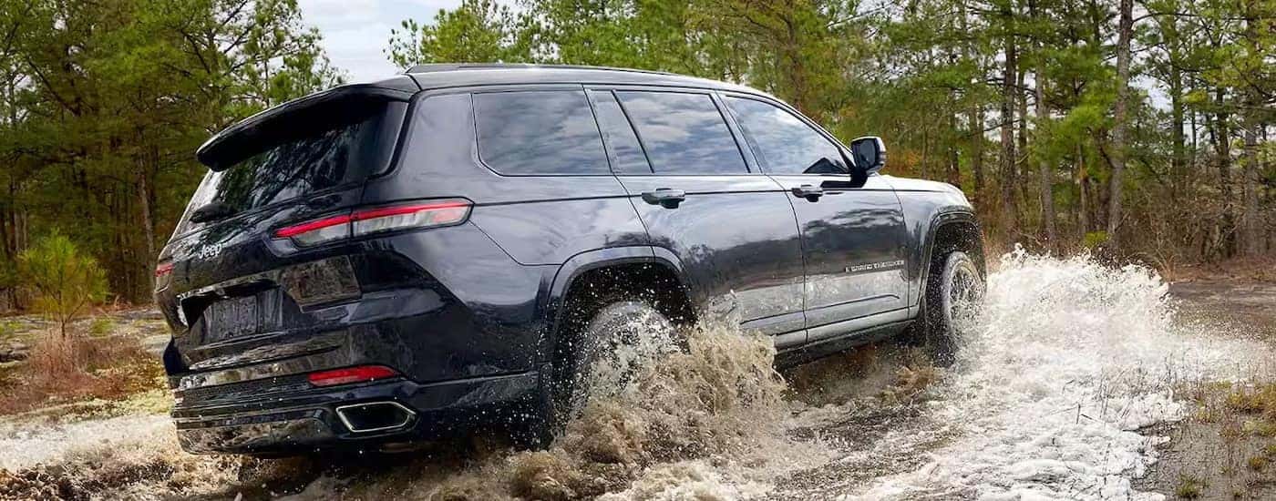 A blue 2025 Jeep Grand Cherokee from the side.