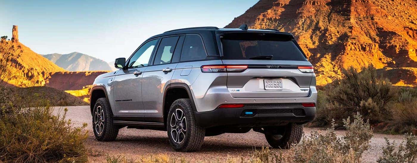 Rear of a grey 2025 Jeep Grand Cherokee L parked off-road.
